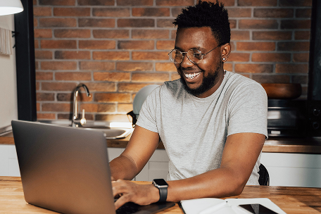 Person smiling at laptop